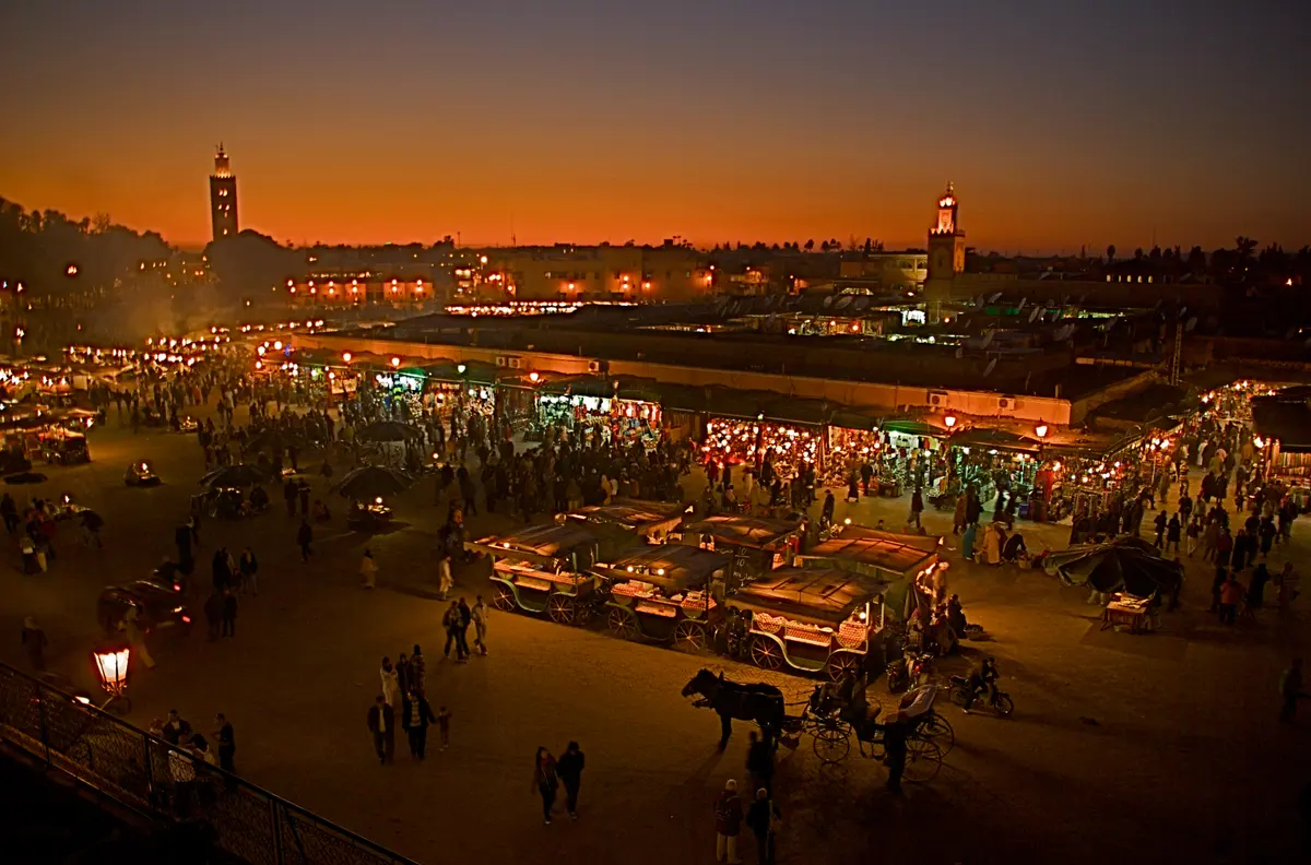Jemaa el-Fnaa square at dusk, with the Koutoubia beyond